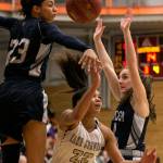 Lake Stevens Raigan Reed (center) attempts a shot with Glacier Peaks Alexyss Newman (left) and Nicole Jensen defending during the 4A district championship on Feb. 15, 2018, at Everett Community College. (Kevin Clark / The Herald)