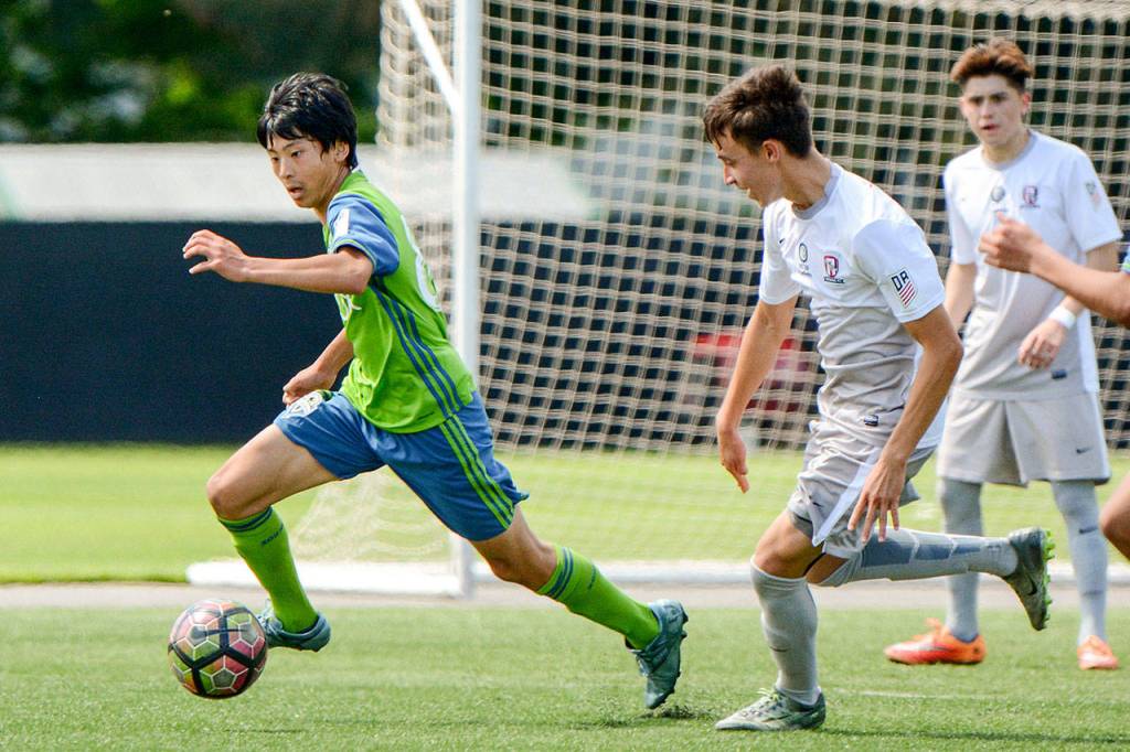 Sota Kitahara, a freshman at Edmonds-Woodway High School, dribbles with the ball during a match with the Seattle Sounders Academy at Starfire Sports in Tukwila. (Sounders Academy photo)