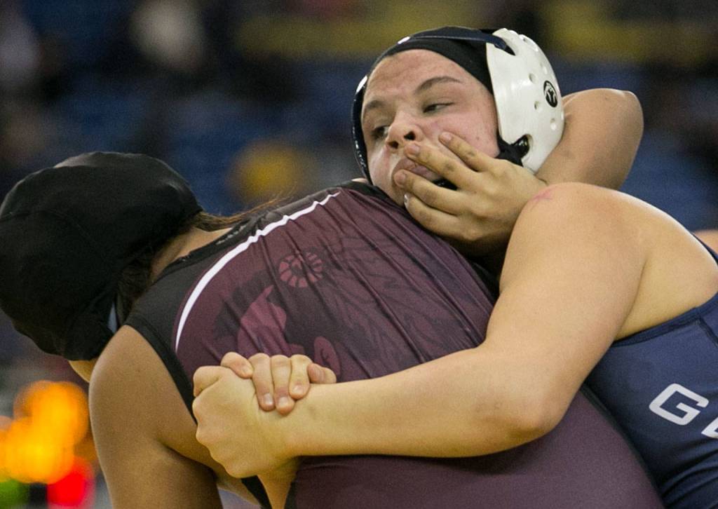 Glacier Peaks Kiley Hubby (right) wrestles Wahlukes Laly Gonzalez-Nunez in the girls 145-pound championship bout at Mat Classic XXX on Feb. 17, 2018, at the Tacoma Dome. (Kevin Clark / The Herald)