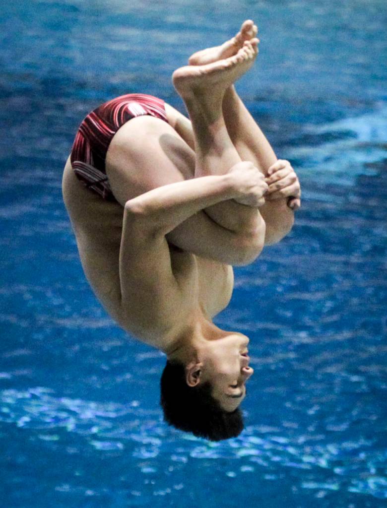 Cascades Joseph Hofman flips through the air on his way to finishing second in the 1-meter dive competition Saturday at the 4A state boys swimming and diving championships at the King County Aquatic Center in Federal Way. (Ian Terry / The Herald)