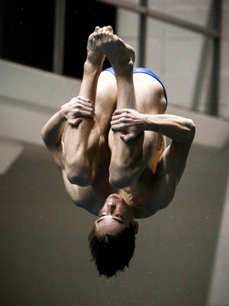 Shorewoods Isaac Poole flips to second place in the 1-meter dive competition Saturday at the 3A state boys swimming and diving championships at the King County Aquatic Center in Federal Way. (Ian Terry / The Herald)