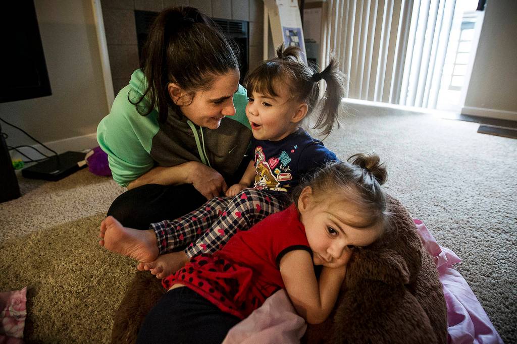 Twin sisters Emma (center) and Chloe Orick, 3, spend time with their mother, Sihaya Sweum, on Feb. 8. The Orick sisters spent time in the hospital for smoke inhalation treatment following a fire at their apartment on Jan. 29 and are now doing well.<strong> </strong>(Ian Terry / The Herald)