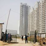 A security man closes a gate leading to the proposed site for the Trump Towers in Gurgaon, a suburb of New Delhi, India, on Tuesday. (AP Photo/Altaf Qadri)