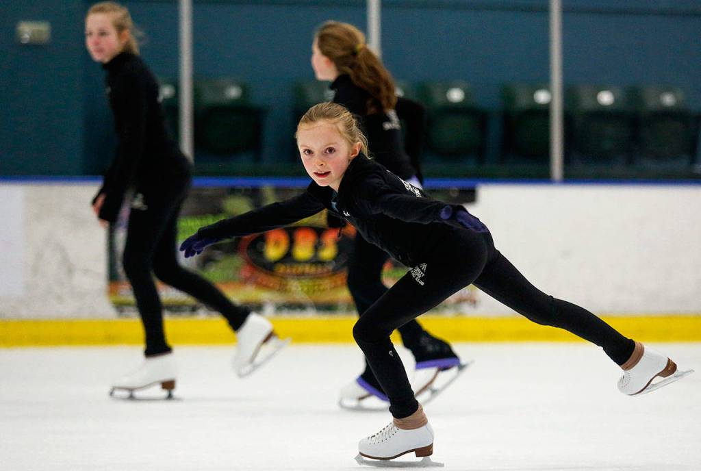 Ashley Stulc glides past fellow skating club members as while working out Thursday in Susannah Hall McAllisters Everett Figure Skating Class. (Dan Bates / The Herald)