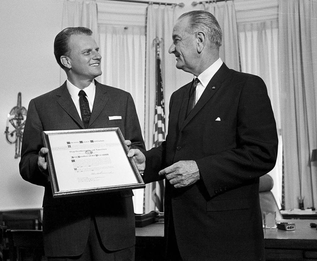 In this May 10, 1966 photo, President Lyndon Johnson presents the Man of the Year award of the Big Brothers organization to evangelist Billy Graham at the White House in Washington. (AP Photo, File)