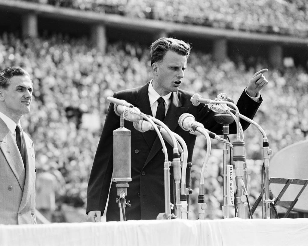 In this June 27, 1954 photo, Evangelist Billy Graham speaks to over 100,000 Berliners at the Olympic Stadium in Berlin, Germany. (AP Photo, File)