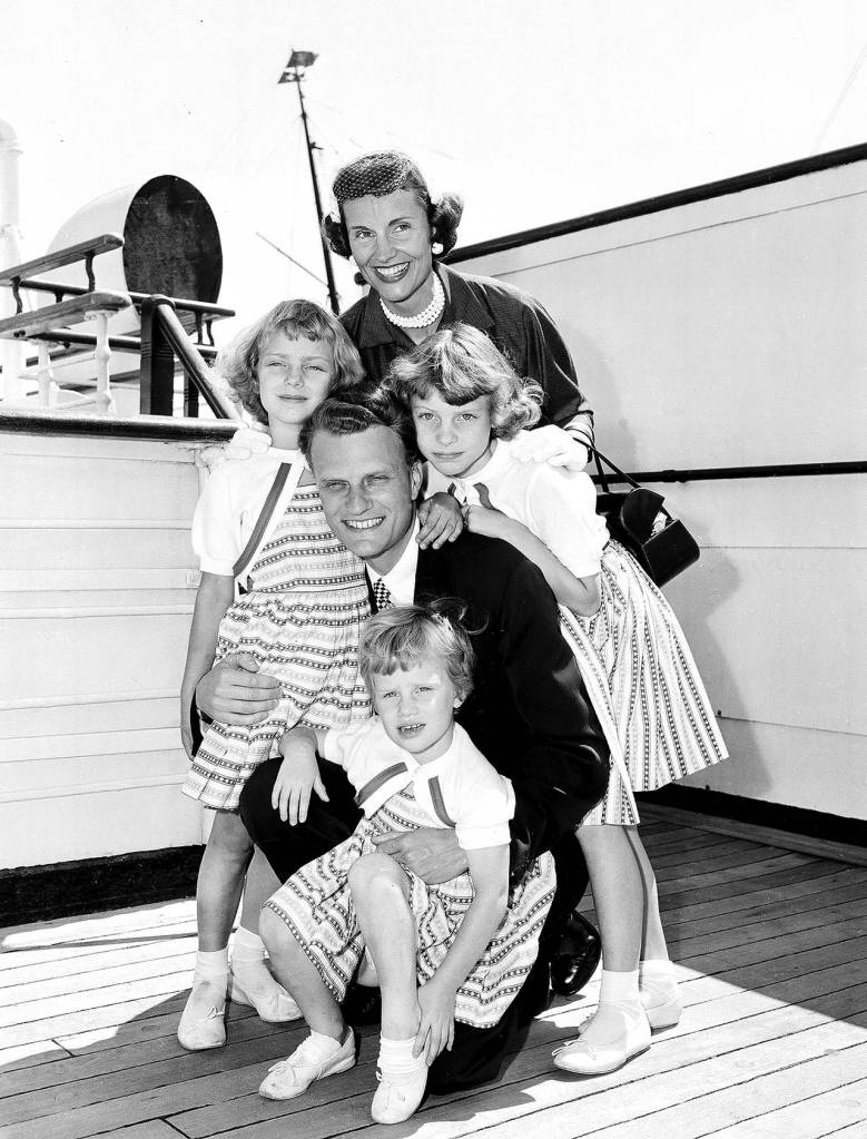 In this July 7, 1954 photo, Evangelist Billy Graham poses with his his wife, Ruth, and their three daughters on the Queen Mary following his arrival in New York. (AP Photo)