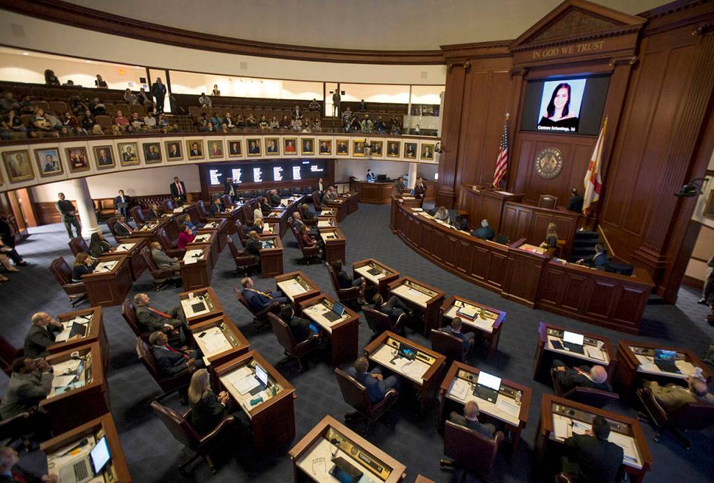 The Florida Senate chamber in Tallahasee is darkened while a slideshow plays of each person killed at Marjory Stoneman Douglas High School. (AP Photo/Mark Wallheiser)