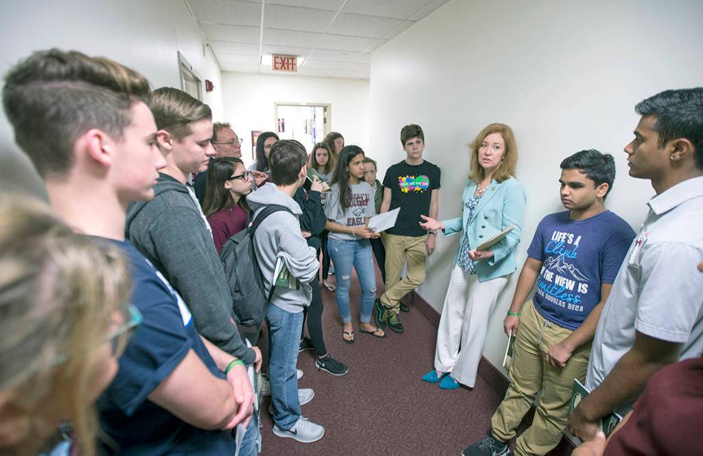 Florida Rep. Kristin Jacobs talks with student survivors from Marjory Stoneman Douglas High School in the hallway at the Florida Capitol in Tallahassee. (AP Photo/Mark Wallheiser)