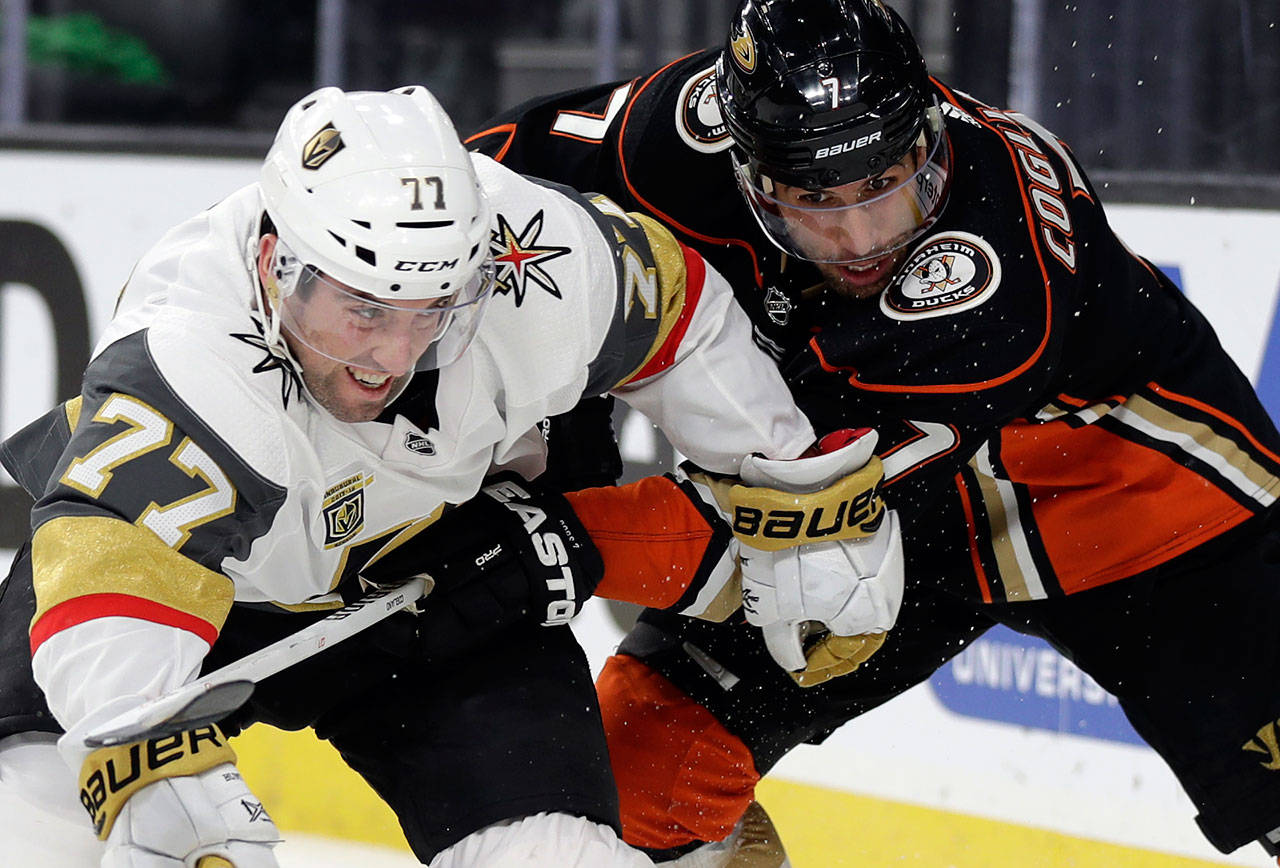 Golden Knights defenseman Brad Hunt (left) and Ducks center Andrew Cogliano struggle for control of the puck during the first period of a game Feb. 19, 2018, in Las Vegas. (AP Photo/Isaac Brekken)