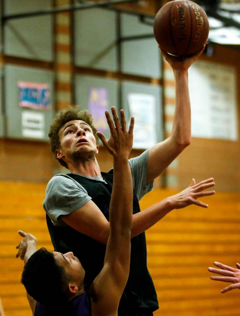 Kamiaks Daniel Sharpe goes up for a shot during a team practice at the Mukilteo school on Friday, Feb. 23. (Ian Terry / The Herald)