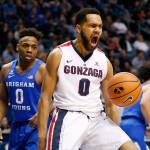Gonzaga guard Silas Melson (0) reacts after dunking the ball while BYU guard Jahshire Hardnett (0) looks on in the first half of a game Feb. 24, 2018, in Provo, Utah. (AP Photo/Rick Bowmer)