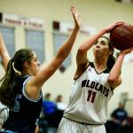 Archbishop Murphys Megan Dorney (right) takes a shot as Lynden Christians Grace Sterk (left) defends during a game on Feb. 1, 2018, at Archbishop Murphy High School in Everett. (Ian Terry / The Herald)