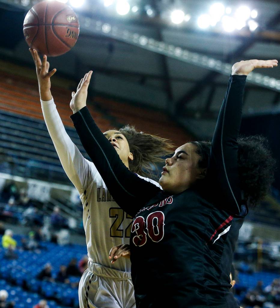 Lake Stevens Raigan Reed (left) takes a shot as Kentlakes Aolani Talamaivao-Calderon (right) defends during a girls 4A state tournament game at the Tacoma Dome on Wednesday, Feb. 28. Kentlake went on to defeat Lake Stevens 57-42. (Ian Terry / The Herald)