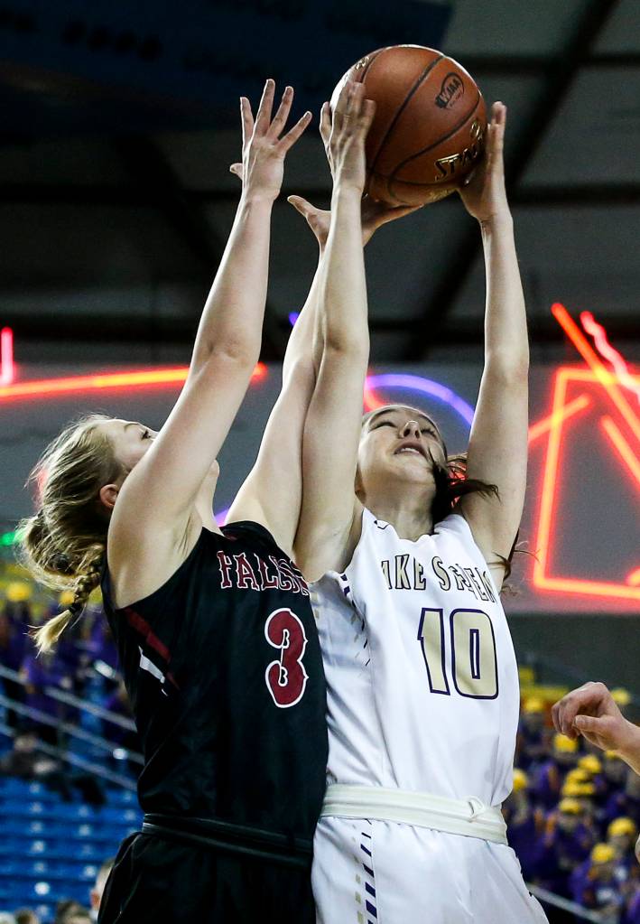 Lake Stevens Laycie Taylor (10) grabs a rebound away from Kentlakes Anna Kruse (3) during a girls 4A state tournament game at the Tacoma Dome on Wednesday, Feb. 28. Kentlake went on to defeat Lake Stevens 57-42. (Ian Terry / The Herald)