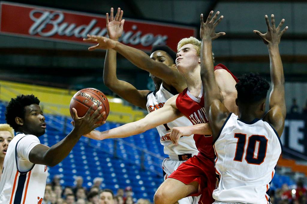 Stanwoods Nate Kummer (center right) has the ball stolen by Eastside Catholics Orlando Ashford (left) along with Shane Nowell (center) Syon Blackmon (right) during a boys 3A state tournament game at the Tacoma Dome on Wednesday, Feb. 28. Eastside Catholic went on to defeat Stanwood 63-37. (Ian Terry / The Herald)