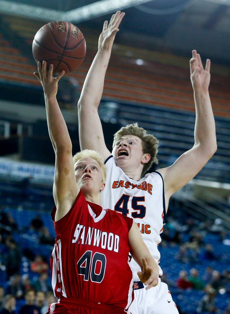 Stanwoods Trygve DeBoer (40) takes a shot as Eastside Catholics Griffin Barker (45) defends during a boys 3A state tournament game at the Tacoma Dome on Wednesday, Feb. 28. Eastside Catholic went on to defeat Stanwood 63-37. (Ian Terry / The Herald)