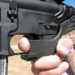 FILE - In this Oct. 4, 2017, file photo, shooting instructor Frankie McRae demonstrates the grip on an AR-15 rifle fitted with a bump stock at his 37 PSR Gun Club in Bunnlevel, N.C. Some states and cities are taking the lead on banning bump stocks as efforts stall in Washington. The controversial device was used in the Las Vegas shooting, allowing a semi-automatic rifle to mimic a fully automatic firearm. Gun-control advocates say the push fits a pattern in gun politics: inaction in Washington that forces states to take charge. (AP Photo/Allen G. Breed, File)