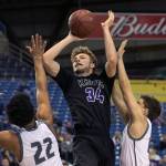 Kamiaks Daniel Sharpe attempts a shot over Unions Alishawuan Taylor (left) and Zach Reznick during the 4A Hardwood Classic on Feb. 28, 2018, at the Tacoma Dome. (Kevin Clark / The Herald)
