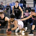 Unions Alishawuan Taylor (center) and Kamiaks Braden Leary dives for a loose ball with Kamiaks Patrick Olson (right) and Kamiaks Dakota Bueing (standing ) looking on during the 4A Hardwood Classic on Feb. 28, 2018, at the Tacoma Dome. (Kevin Clark / The Herald)