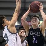 Kamiaks Carson Tuttle attempts a shot over Unions Zach Reznick during the 4A Hardwood Classic on Feb. 28, 2018, at the Tacoma Dome. (Kevin Clark / The Herald)