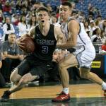 Kamiaks Carson Tuttle drives the baseline with Unions Coby Weatherspoon defending during the 4A Hardwood Classic on Feb. 28, 2018, at the Tacoma Dome. (Kevin Clark / The Herald)