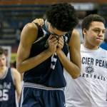 Glacier Peaks Trey Lawrence (left) is comforted by teammate Tony Collins after loosing to Skyview High in the WIAA state basketball tournament Wednesday at the Tacoma Dome in Tacoma on February 28, 2018. (Kevin Clark / The Daily Herald)