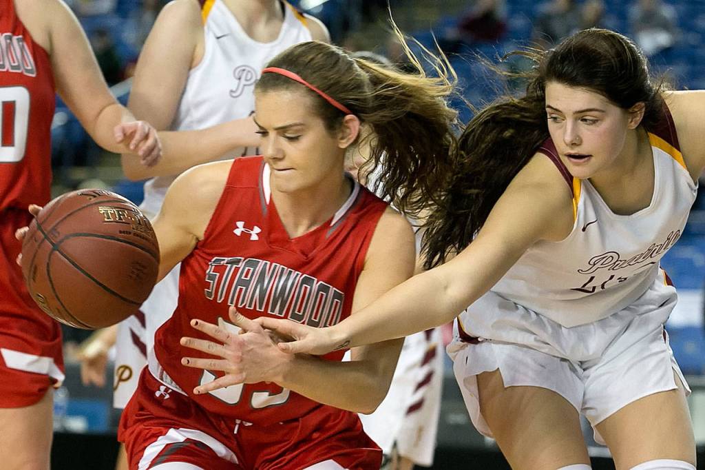 Stanwoods Ashley Alter gathers a loose ball with Prairies Mallory Williams reaching in during the WIAA state basketball tournament Wednesday at the Tacoma Dome in Tacoma on February 28, 2018. (Kevin Clark / The Daily Herald)