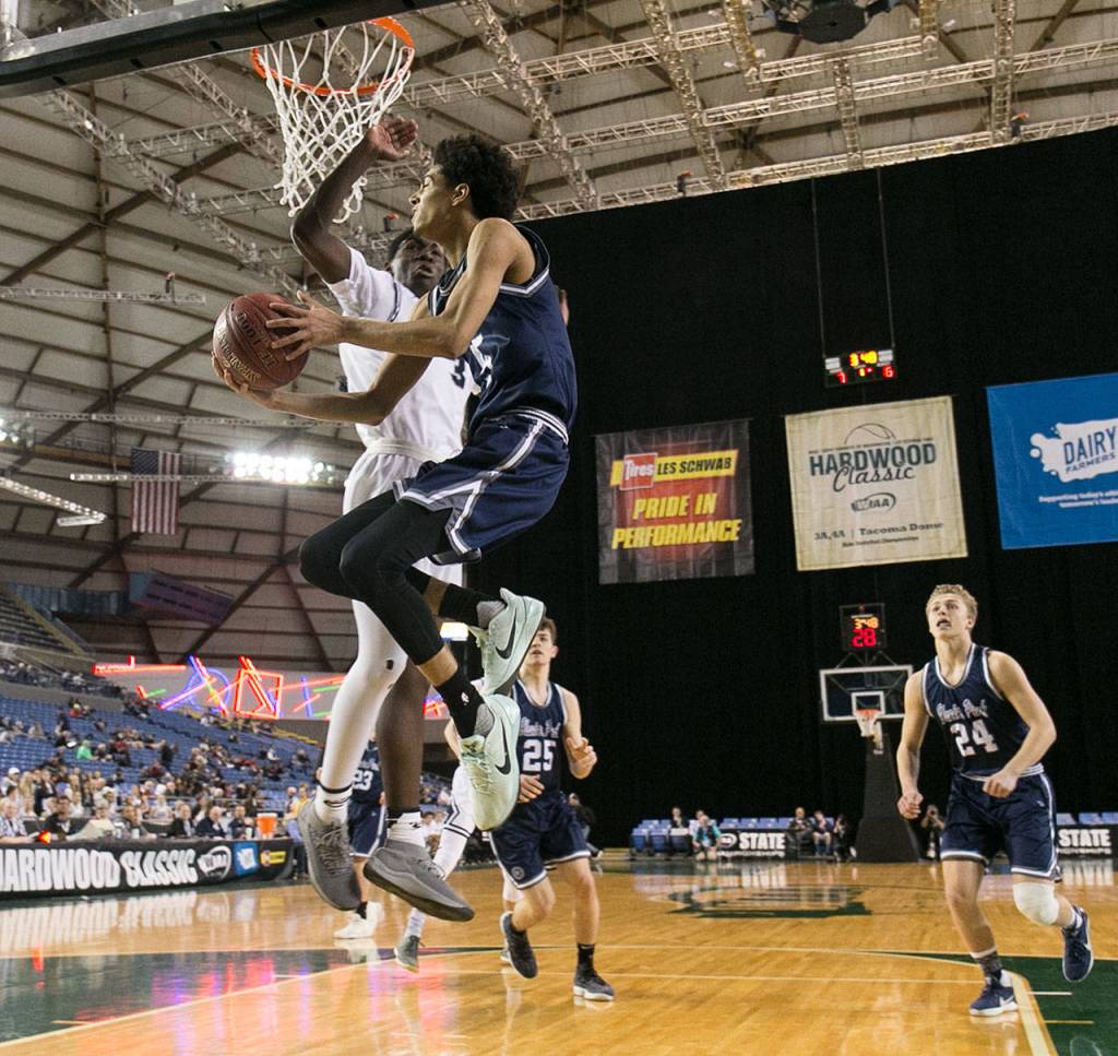 Glacier Peaks Trey Lawrence attempts a shot with Skyviews Samaad Hector defending during the WIAA state basketball tournament Wednesday at the Tacoma Dome in Tacoma on February 28, 2018. (Kevin Clark / The Daily Herald)