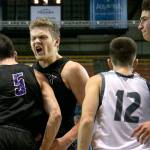 Kamiaks Patrick Olson (5) gets a celebratory bump form teammate Landon Overturf with Unions Tyler Combs (12) and Unions Jason Franklin Jr. during the WIAA state basketball tournament Wednesday at the Tacoma Dome in Tacoma on February 28, 2018. (Kevin Clark / The Daily Herald)