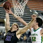 Kamiaks Braden Leary has his shot blocked by Richlands Riley Sorn during a 4A boys Hardwood Classic game on March 1, 2018, at the Tacoma Dome. (Kevin Clark / The Herald)
