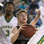 Kamiaks Carson Tuttle looks for a shot with Richlands Dhaunye Guice trailing during the WIAA state basketball tournament Wednesday at the Tacoma Dome in Tacoma on March 1, 2018. (Kevin Clark / The Daily Herald)