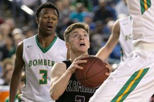 Kamiaks Carson Tuttle looks for a shot with Richlands Dhaunye Guice trailing during the WIAA state basketball tournament Wednesday at the Tacoma Dome in Tacoma on March 1, 2018. (Kevin Clark / The Daily Herald)