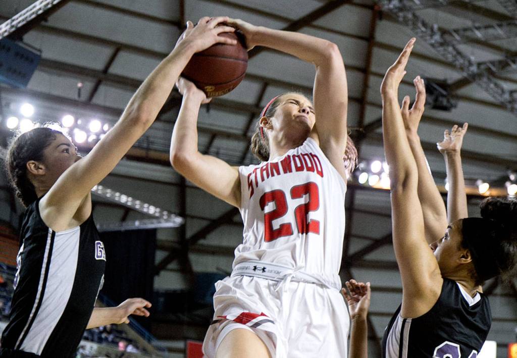 Stanwoods Ashley Alters shot is blocked by Garfields Dalayah Daniels (left) with Garfields Niveya Henley defending during the semifinals of the 3A Hardwood Classic on March 2, 2018, at the Tacoma Dome. (Kevin Clark / The Herald)