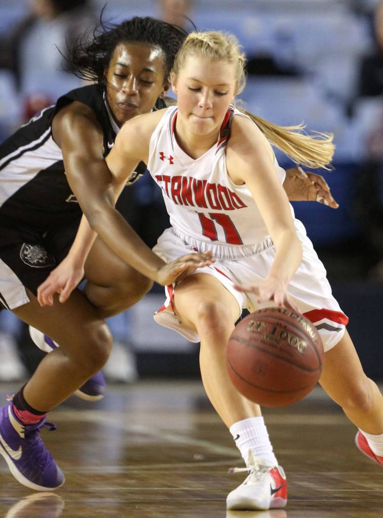 Garfields Emani Turner reaches across Stanwoods Shelby Lund during the semifinals of the 3A Hardwood Classic on March 2, 2018, at the Tacoma Dome. (Kevin Clark / The Herald)