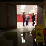 Mike Johnson (from left) Melody Clemans and Terry Lippincott visit the water damaged annex of the Carnegie library building in Snohomish on Wednesday. (Kevin Clark / The Herald)