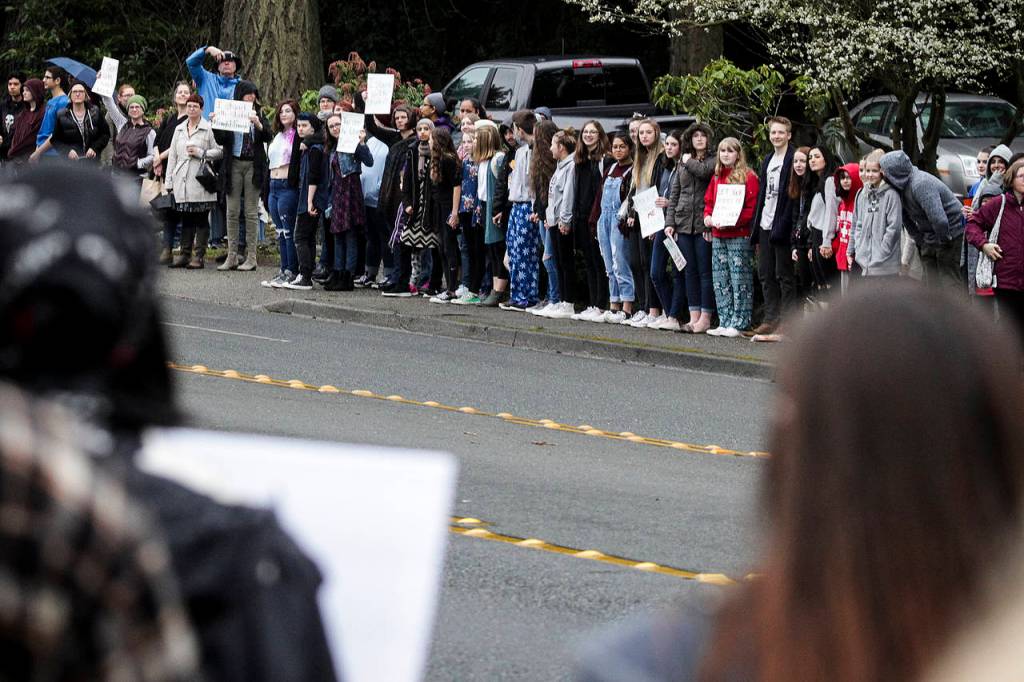 Students who walked out of class line 100th Avenue West in Edmonds on Wednesday. (Ian Terry / The Herald)