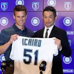 Ichiro Suzuki (right) holds up his jersey with Mariners general manager Jerry Dipoto during a news conference at the teams spring training complex on Wednesday in Peoria, Ariz. Ichiro, who starred in Seattle from 2001 until he was traded in 2012, signed a one-year deal to return to the Mariners. (AP Photo/Matt York)