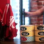 Customers stack cans of Cougar Gold, a sharp white cheddar, on the counter at the WSU store. The store is slated to close this summer after no longer making a profit. (File photo)