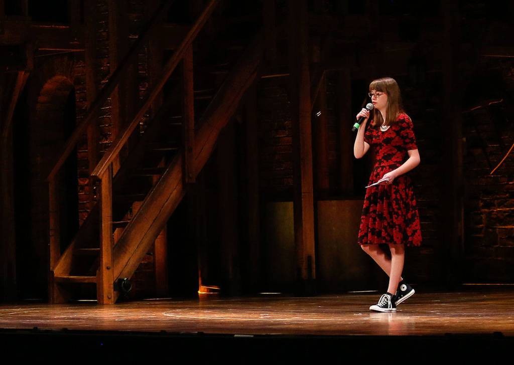 Marysville Pilchuck junior Laura Davis, 17, performs her original poem on stage in the Paramount Theatre on Wednesday. (Dan Bates / The Herald)