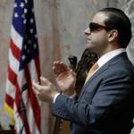 Lt. Gov. Cyrus Habib applauds as he presides over the Senate following a vote on the supplemental budget, Thursday at the Capitol in Olympia, on the final day of the regular session of the Legislature. (Ted S. Warren/Associated Press)