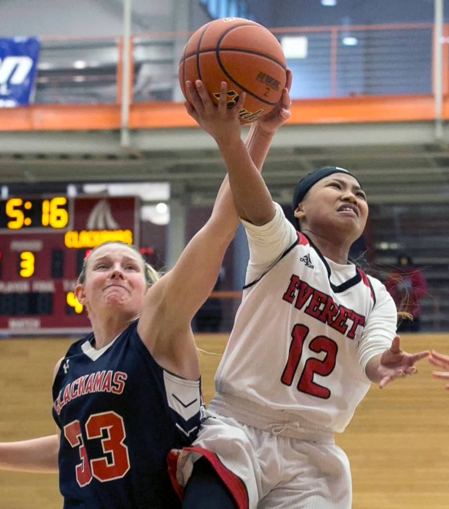 Clackamas Ricki Mock blocks a shot attempt by Everetts Aloha Salem at Everett Community College on March 8. (Kevin Clark / The Herald)