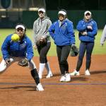 Edmonds Community Colleges Kalei Cacho-Kekahuna (left) fields a ground ball with (from left) Aubri Burwood, Chantelle Simabukuro, McKenzie Beavin and Tamia Hirano waiting their turn during the Tritons softball practice in Lynnwood. (Kevin Clark / The Herald)