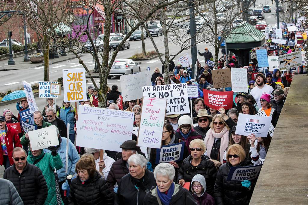 Thousands of protesters walk along Hewitt Avenue near the Angel of the Winds Arena in downtown Everett during a March for Our Lives rally on Saturday. (Ian Terry / The Herald)