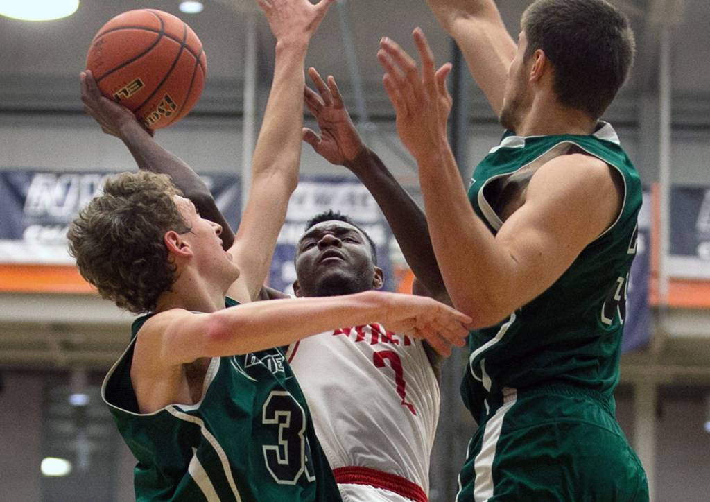 Everetts Gio Jackson attempts a shot with Chemeketas Jason Richey (left) and Stepan Zavydovskyy defending during the NWAC Basketball Tournament at Everett Community College on March 10. (Kevin Clark / The Herald)