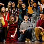 Marysville Pilchuck junior Laura Davis, in the flowered dress, joins other high school students from the region on the Paramount stage at the conclusion of student performances Wednesday. (Dan Bates / The Herald)