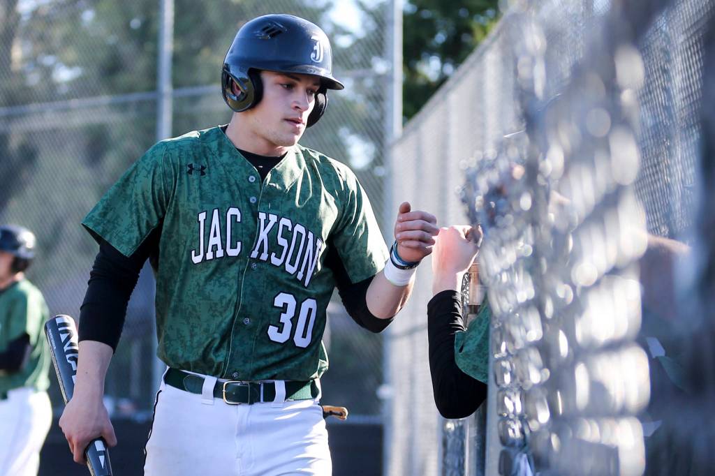 Carter Booth, Jackson senior outfielder, makes his way to the dugout after scoring at Jackson High School against Marysville-Getchell on March 15. (Kevin Clark / The Herald)