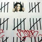 Graffiti is painted on top of a mural in New York by British graffiti artist Banksy that protests the imprisonment of Turkish artist and journalist Zehra Dogan. (Shelly Acoca / Associated Press)