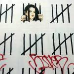 Vandal tags mural created by British graffiti artist Banksy