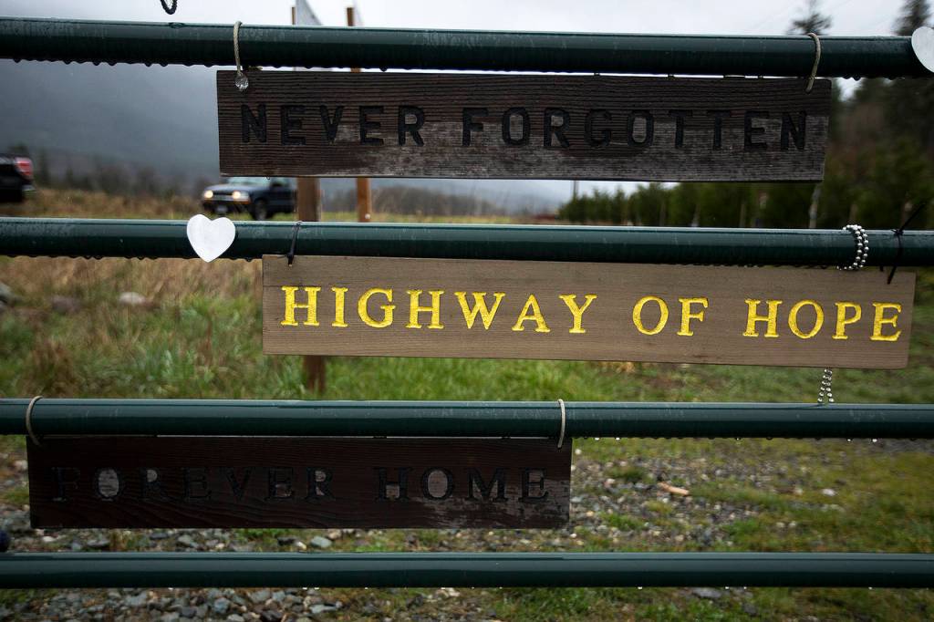 A new sign was hung by Oso resident Ron Thompson on a gate leading to a memorial site for the 2014 Oso mudslide. (Ian Terry / The Herald)
